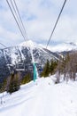 Skiers on Chairlift Up a Ski Slope in the Canadian Rockies Royalty Free Stock Photo