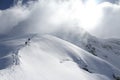 Skiers climbing a snowy mountain Royalty Free Stock Photo