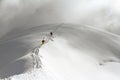 Skiers climbing a snowy mountain Royalty Free Stock Photo