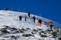 Skiers climbing up from Imperial Express chair lift to the top of the mountain to make free ride from the peak.