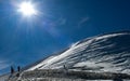 Skiers climbing up to the summit of Emperial bowl area of Breckenridge ski resort. Extreme winter sports. Royalty Free Stock Photo