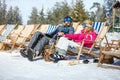 Skiers couple in sun lounger enjoy on sun Royalty Free Stock Photo