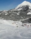 Skiers descend to tiny mountain village Royalty Free Stock Photo