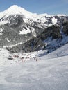 Skiers descend to tiny mountain village Royalty Free Stock Photo