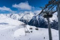 Skiers and double chairlift in Alpine ski resort in Solden