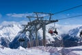 Skiers and double chairlift in Alpine ski resort in Solden