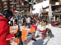 Skiers enjoy lunch outdoors in the sun