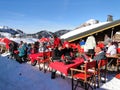 Skiers enjoy their lunch on a sunny day