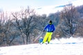 Skier descends a steep slope from a mountain Royalty Free Stock Photo