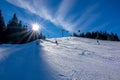 Skiers Go Down a Wide Slope and Sun