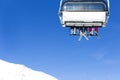 Skiers going up on the chairlift against bright blue sky- ski re Royalty Free Stock Photo