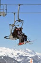 Skiers going up with a ski lift