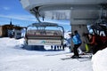 Skiers going up with a ski lift in the Alps