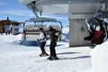 Skiers going up with a ski lift in the Alps