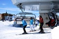 Skiers going up with a ski lift in the Alps