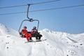 Skiers going up with a ski lift