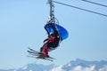 Skiers going up with a ski lift at ski resort. Austrian Alps