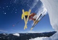 Skiers Launching Off Snow Bank Hitting The Slopes