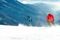 Skiers making downhill ride from the top of a mountain Royalty Free Stock Photo