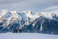 Skiers mountains in the background