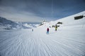 Skiers on a piste in alpine ski resort