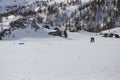 Skiers preparing for kite skiing near to mountain cabins on Simplon Pass, Switzerland