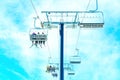 Skiers Riding Chairlift Isolated against Blue Sky Royalty Free Stock Photo