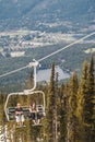 Skiers riding on ski lift in Whistler, Canada.