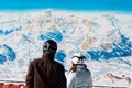 Skiers with safety helmets in front of ski map