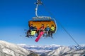 Skiers sitting on ski lift chair in ski resort Jasna in Low Tatras mountains, Slovakia