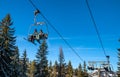 Skiers sitting on ski lift chair in resort Jasna, Slovakia