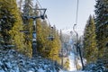 Skiers sitting on ski lift chair in resort Jasna, Slovakia