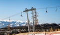 Skiers sitting at ski-lift chairs in resort Tatranska Lomnica, Slovakia