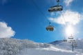 Skiers in a ski lift in snowy mountains Royalty Free Stock Photo