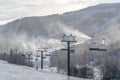 Skiers on ski lifts overlooking scenic ski resort