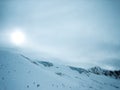 Skiers on ski slope in blizzard snowstorm in mountains on Hintertux Glacier, Zillertal Valley