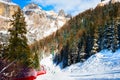 Skiers skiing down the slope in ski resort in Dolomite Alps Royalty Free Stock Photo