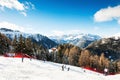 Skiers skiing down the slope in Val Di Fassa ski resort in Dolomites, Italy Royalty Free Stock Photo