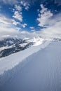 Skiers skiing in Kitzbuehel ski resort and enjoying Alps view fr