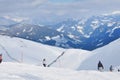 Skiers skiing on the piste in the Alps