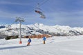 Skiers on slopes and chairlifts in alpine resort