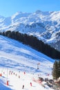 Skiers on the slopes of the ski resort of Meriber