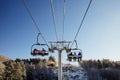 Skiers and snouborders on snow slope in winter ski resort. Ski elevator on snow mountain. Winter activity concept. Cable car ski