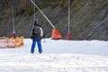 skiers on a snow slope for beginners on a sunny day.