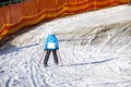 skiers on a snow slope for beginners on a sunny day.