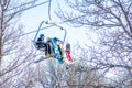 Skiers and snowboarders climb the mountain by cable car Royalty Free Stock Photo