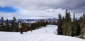 Skiers and snowboarders descend a run at Keystone mountain in Colorado on a winter morning in November Royalty Free Stock Photo