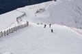 Skiers and snowboarders going down the slope. Royalty Free Stock Photo