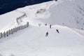 Skiers and snowboarders going down the slope. Royalty Free Stock Photo