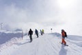 Skiers and snowboarders going down the slope. Royalty Free Stock Photo